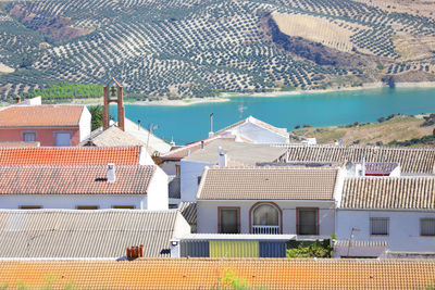 High angle view of town by sea against sky