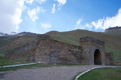 Old ruins of building against cloudy sky