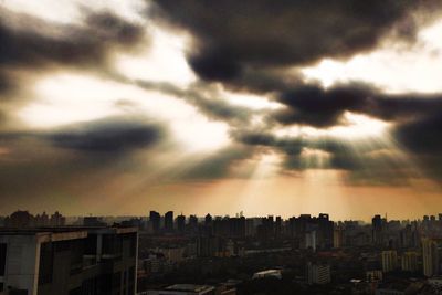 Cityscape against cloudy sky