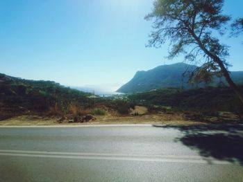 Empty road along countryside landscape