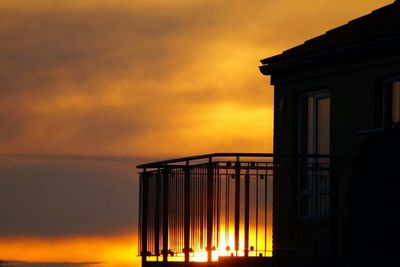 Low angle view of built structure against sky at sunset