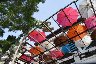 Low angle view of umbrellas against sky