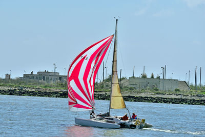 Sailboat on sea against sky