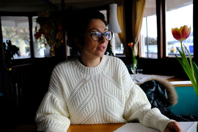 Thoughtful woman sitting in cafe