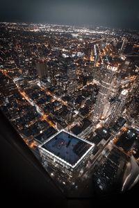 High angle view of city lit up at night