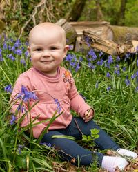 Portrait of happy boy sitting on grass