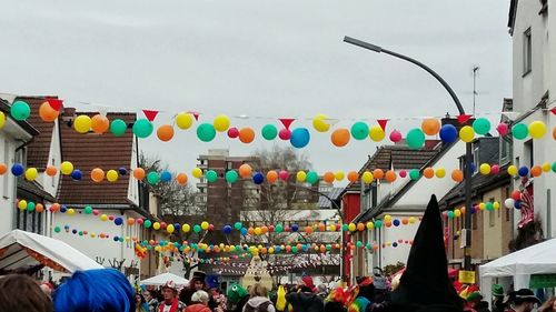 Group of people at street market against sky