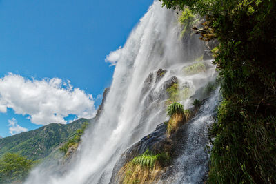 Scenic view of waterfall against sky