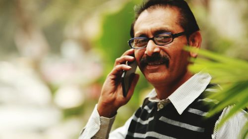 Portrait of mature man talking on phone