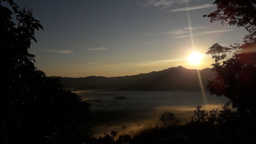 Scenic view of silhouette mountains against sky at sunset