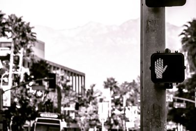 Close-up of road sign against sky