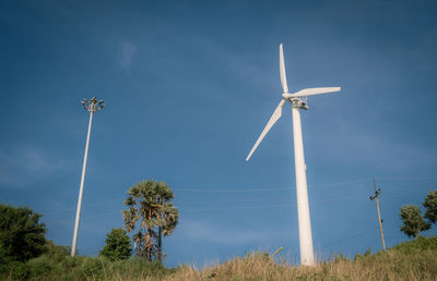 Low angle view of windmill against sky