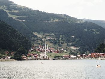 Scenic view of sea and buildings against sky