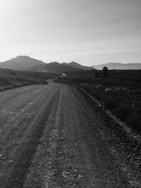 Country road passing through field