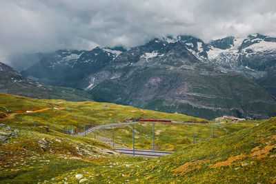 Railway and red train in gornergrat mountains. zermatt, swiss alps. adventure in switzerland.