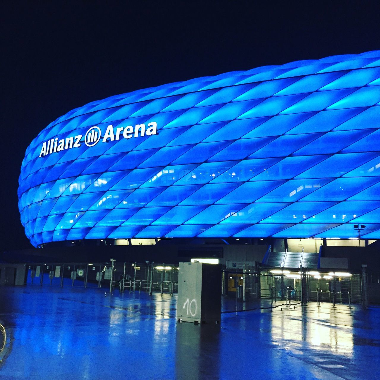 blue, text, illuminated, night, communication, reflection, built structure, architecture, western script, building exterior, water, neon, sky, modern, waterfront, no people