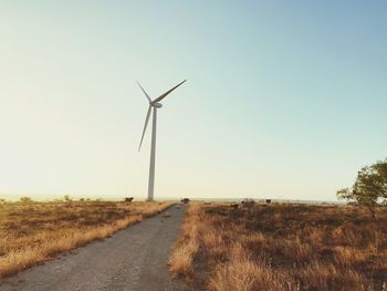 Windmill on field against clear sky