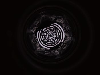 Directly below shot of spiral metal against black background