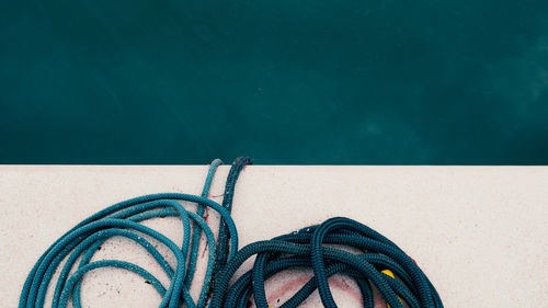 High angle view of rope tied to swimming pool