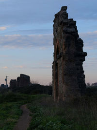 Old ruins on field against sky