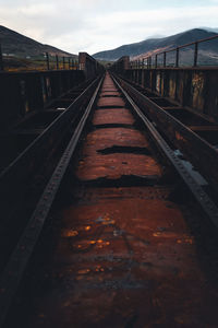 Surface level of railroad tracks against sky