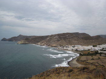 Scenic view of sea and mountains against sky