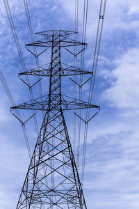 Low angle view of electricity pylon against sky