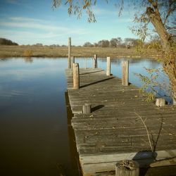 Pier on lake against sky