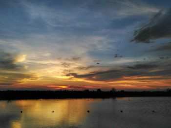 Scenic view of lake against romantic sky at sunset