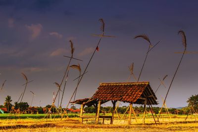 Traditional windmill on field against sky