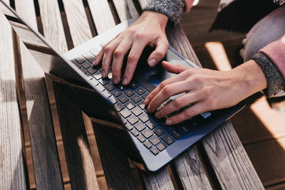 Midsection of man using laptop on table