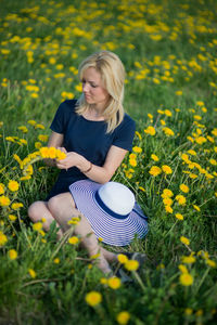 Portrait of young woman with yellow flowers