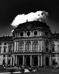 Low angle view of building against cloudy sky