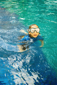 High angle view of boy swimming in pool