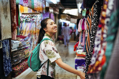 Full length of woman standing at market stall