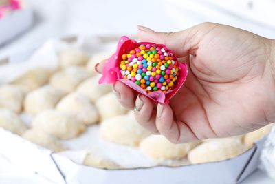 Cropped hand of woman holding sweet food