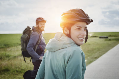 Germany, schleswig-holstein, eiderstedt, couple on a bicycle tour having a break in marsh landscape