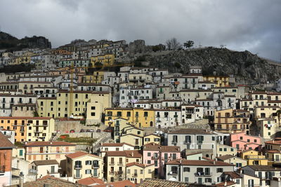 Buildings in town against sky