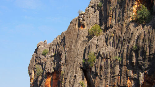 Low angle view of rock formation against sky