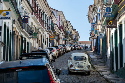 Cars on street amidst buildings in city