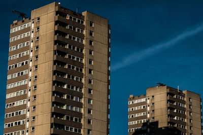 Residential buildings against blue sky