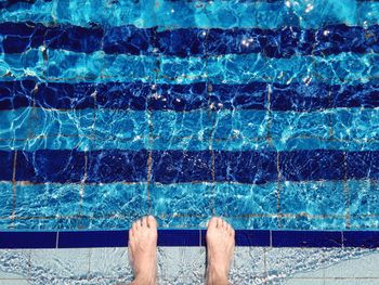 Person standing on the edge of swimming pool