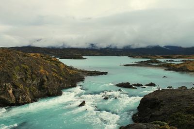 Scenic view of mountains against cloudy sky