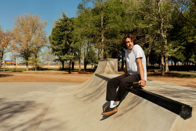 Young man sitting in park