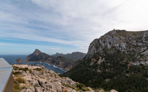 Scenic view of sea and mountains against sky