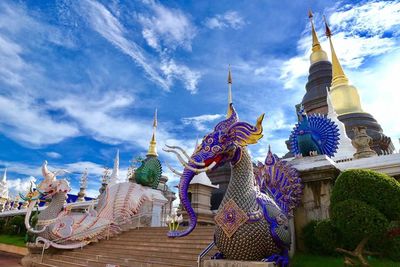 Statue of temple against cloudy sky