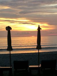 Silhouette of beach against sky during sunset