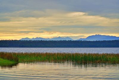 Scenic view of lake against sky during sunset
