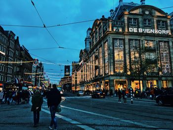 People in city against sky