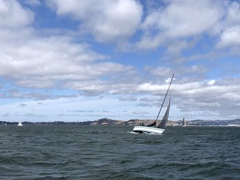 Sailboat sailing on sea against sky